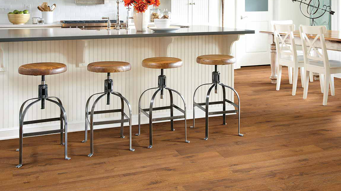Riverdale Hickory by Shaw' laminate floor in kitchen featuring island and bar stools