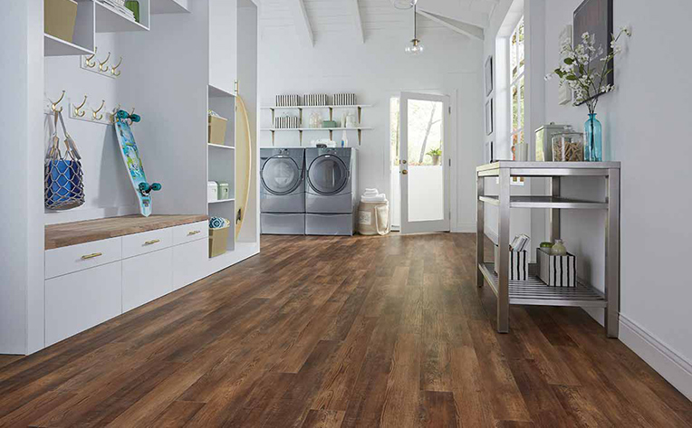 Dark Hardwood Floor in mud room with washer and dryer